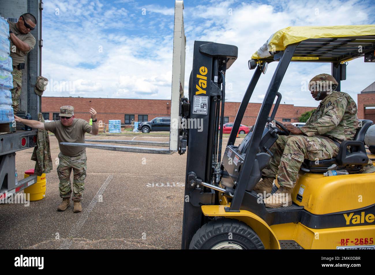 Mississippi National Guard Soldiers load a pallet of water with a forklift at Northwest Jackson