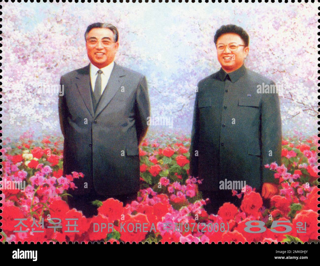 2008 North Korea postage stamp featuring Kim Il-sung and Kim Jong-il in a field of red Kimjongilia begonias. Stock Photo