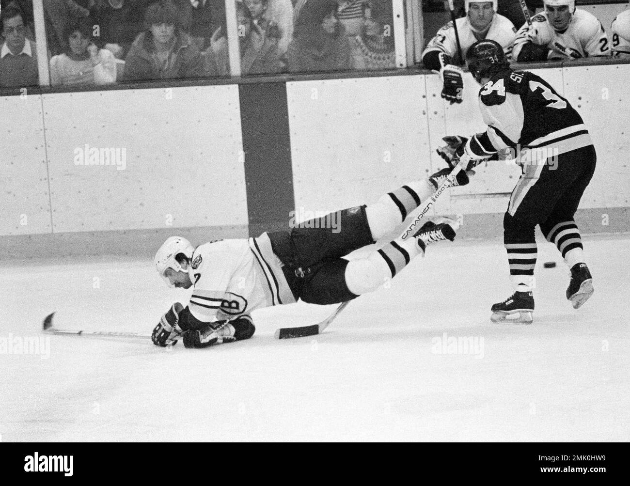 Boston Bruins defenseman Ray Bourque shows his son Christopher, 1 1/2,  proper ice hockey form during the team's annual Christmas party for  players, coaches, and their families, held on the Boston Garden