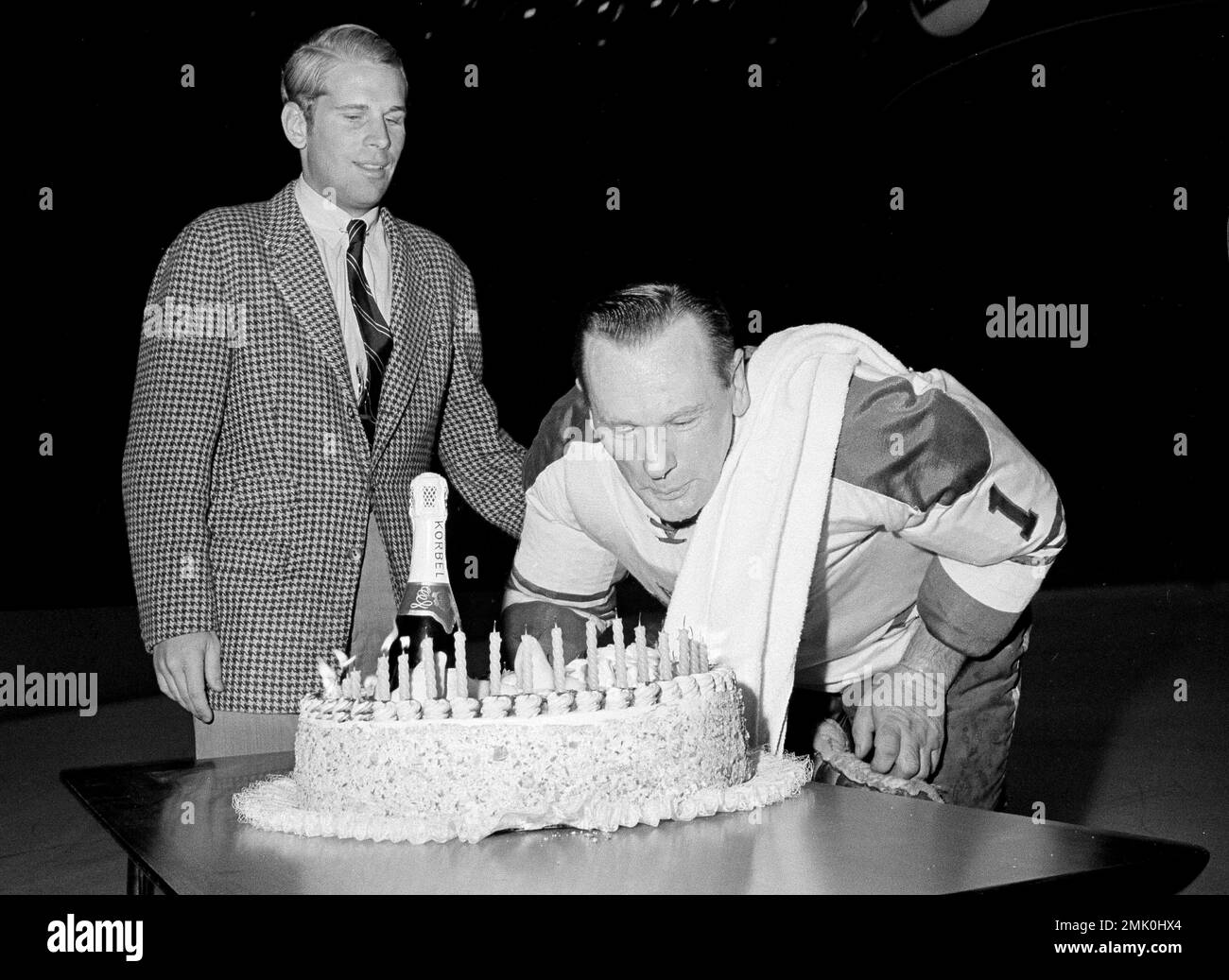 Toronto Maple Leafs goalie Johnny Bower blows out the candles on his ...