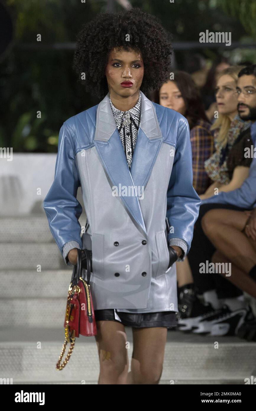 A model, bag detail, walks the runway during the Louis Vuitton