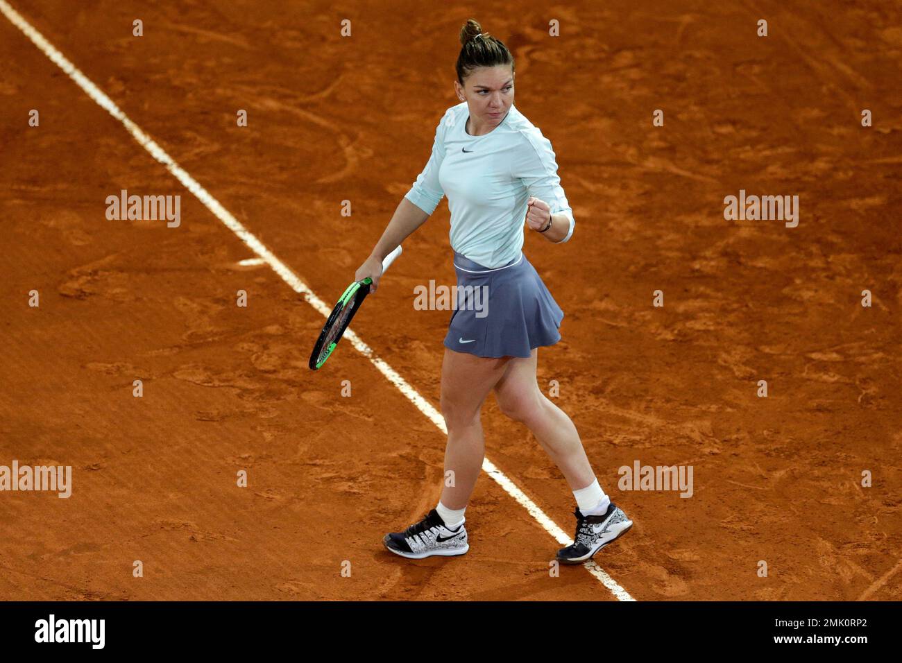 Simona Halep, of Romania, celebrates at the end of her match against  Viktoria Kuzmova, of Slovakia, during the Madrid Open tennis tournament,  Wednesday, May 8, 2019, in Madrid, Spain. (AP Photo/Andrea Comas