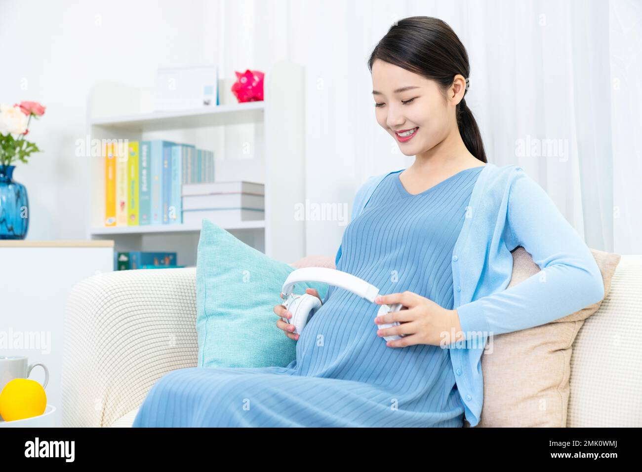Pregnant women put headphones on the belly Stock Photo Alamy