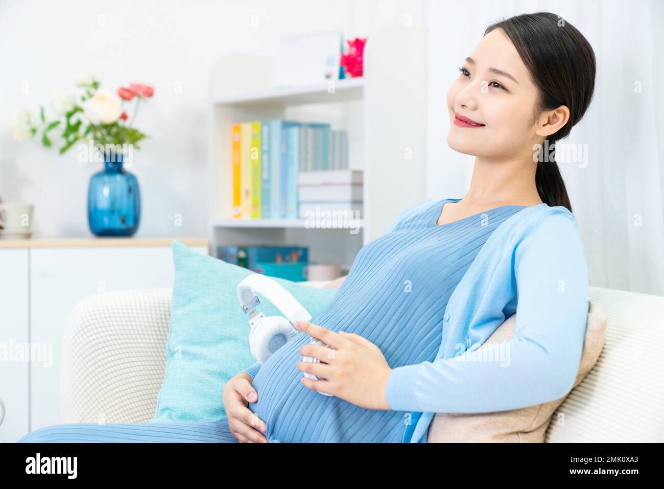 Pregnant women put headphones on the belly Stock Photo Alamy