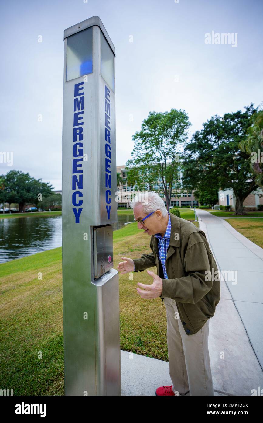 Old senior man calling for help at a public safety beacon emergency ...
