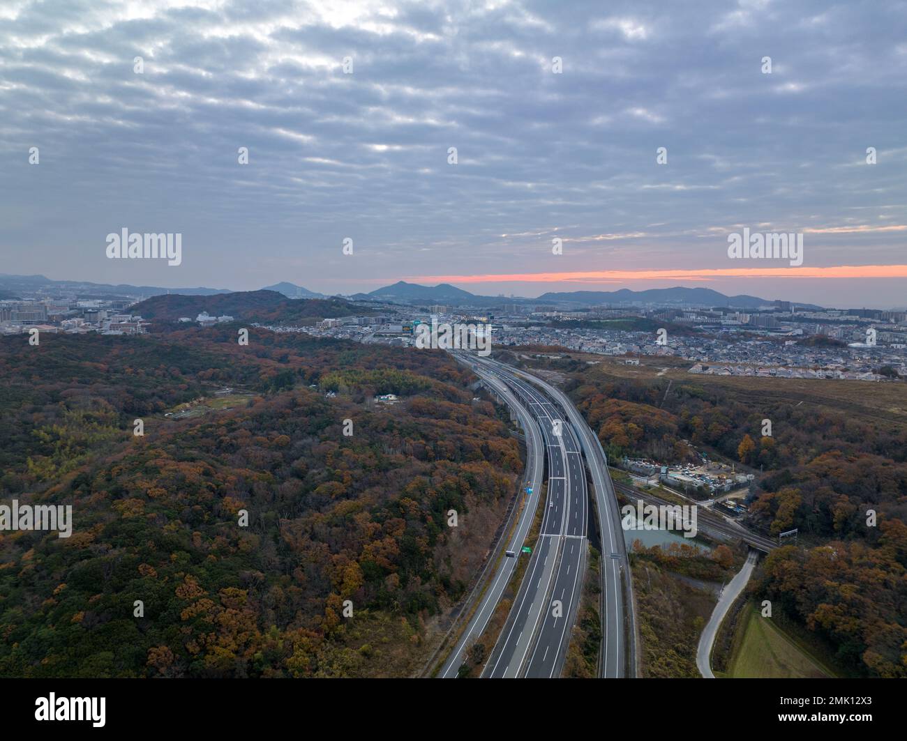 Empty road toward distant hills with predawn color in sky Stock Photo