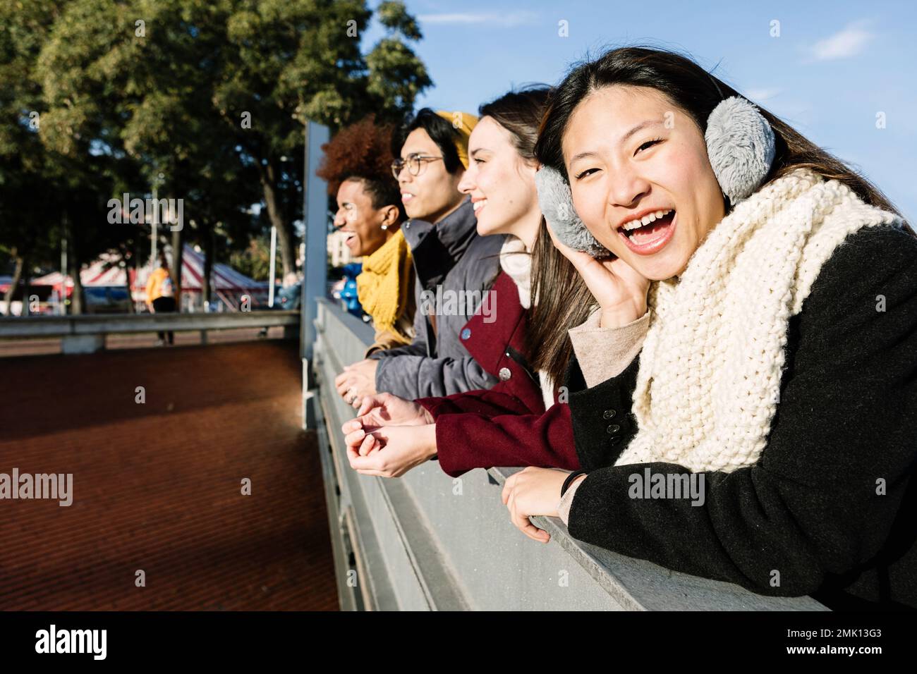 Young group of multi-ethnic friends enjoying sunset together in the city Stock Photo
