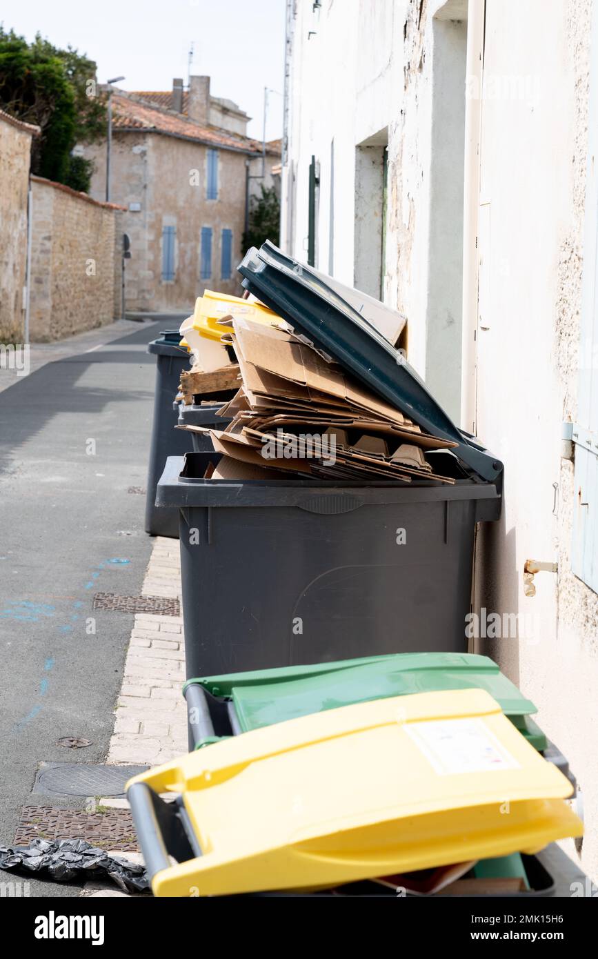 Recycling boxes full trash can of cardboard in street city Stock Photo