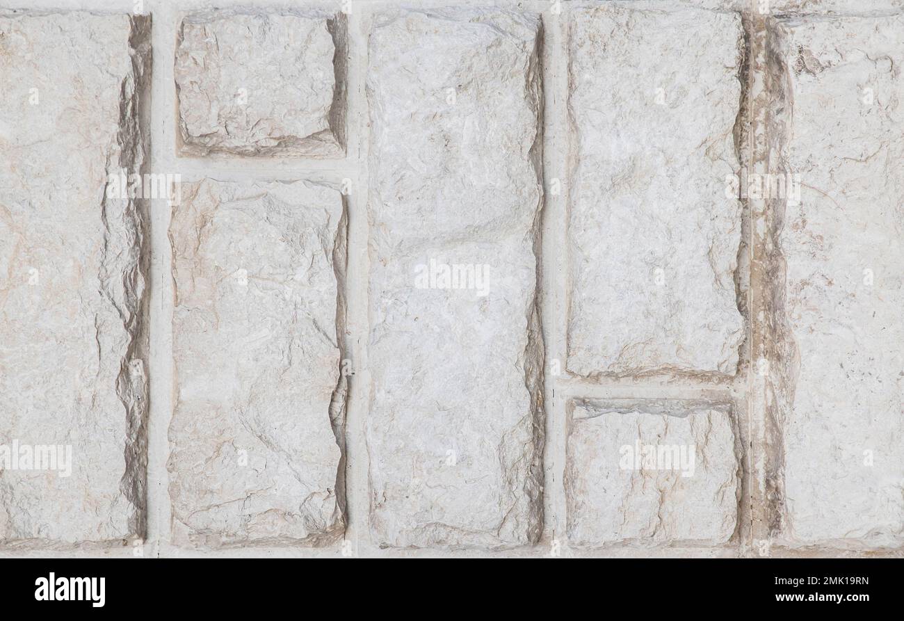 Gray wall lined with stone slabs. Background Stock Photo