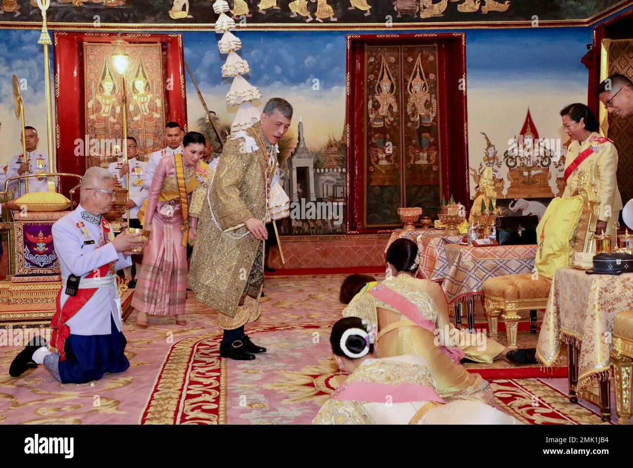 In this photo released by Bureau of the Royal Household, Thailand's King  Maha Vajiralongkorn, center, and Queen Suthida, behind the King participate  in rituals he is officially crowned king at the Grand
