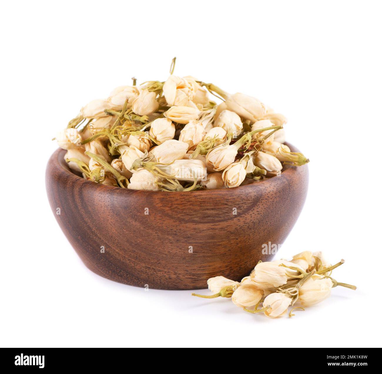 Dry jasmine flowers in wooden bowl, isolated on white background. Jasmine flowers tea. Herbal