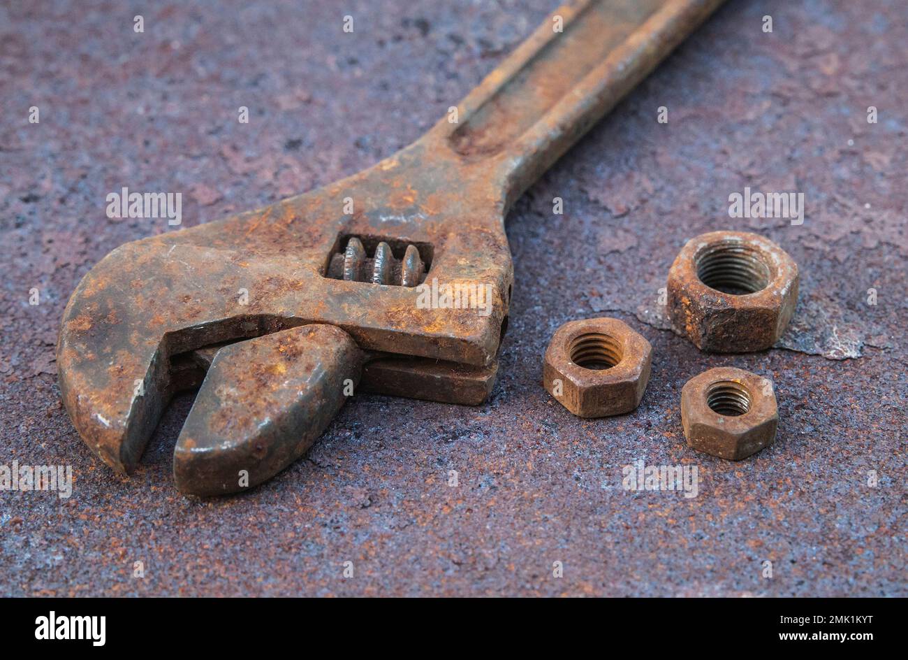 Old wrench and nuts on a rusty countertop Stock Photo Alamy
