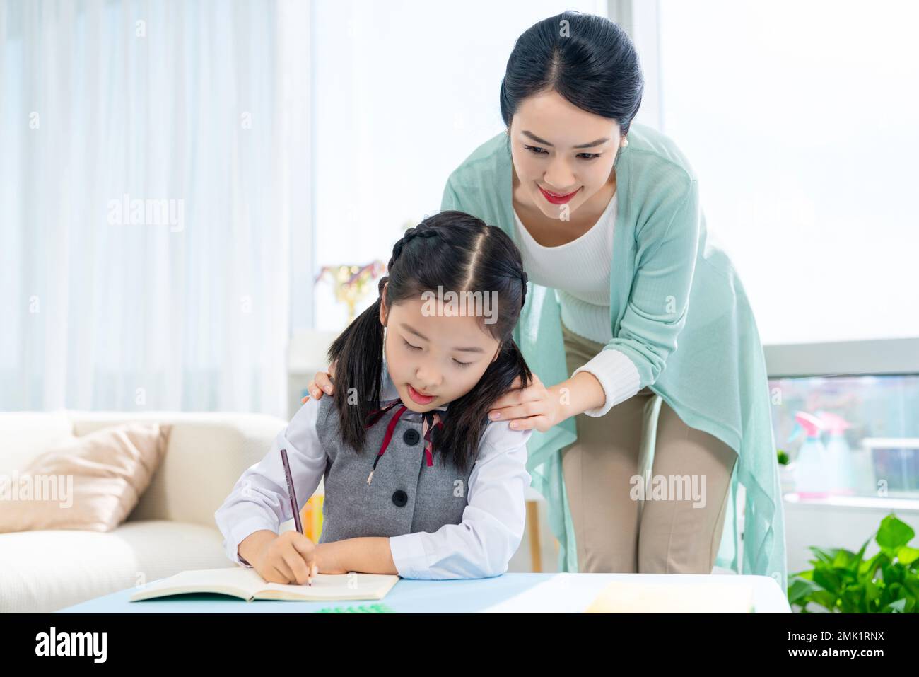 Mother to do homework with your child Stock Photo