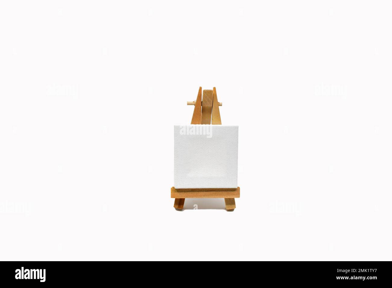 Small white easel with blank canvas isolated on a plain white