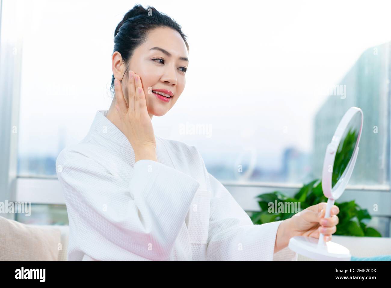 The young woman looked in the mirror Stock Photo - Alamy