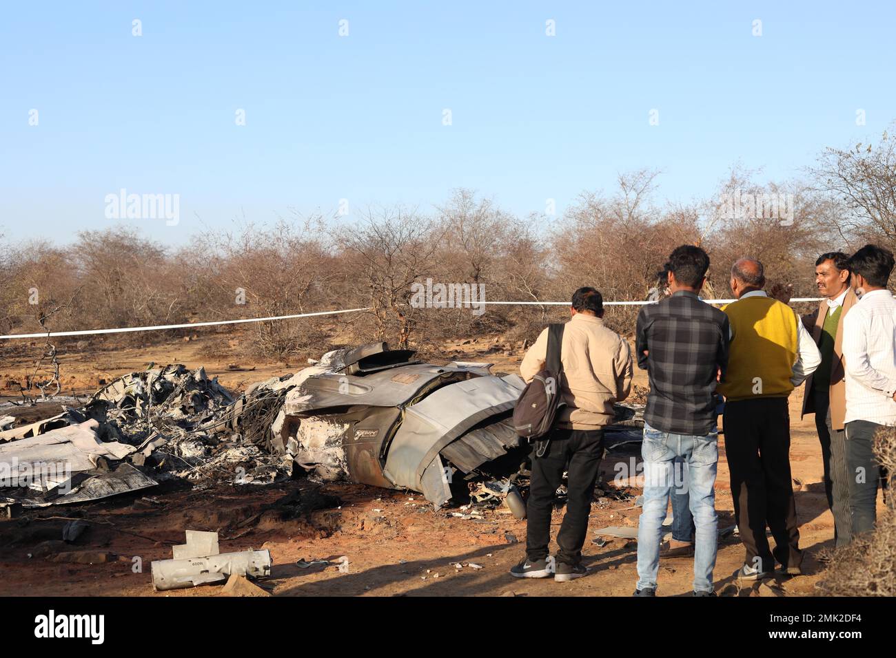 Jabalpur, India. 28th Jan, 2023. Gwalior, Madhya Pradesh, India, January, 28,2023. People stand near the wreckage of an aircraft after a Sukhoi Su-30 and Dassault Mirage 2000 fighter jet crashed during an exercise in Pahargarh area, about 50 kilometers (30 miles) from Gwalior, Madhya Pradesh on January 28, 2023. Police present at the accident site said that there was an apparent mid-air collision during the exercise on 28 January. Photo By - Uma Shankar Mishra Credit: River Ganga/Alamy Live News Stock Photo