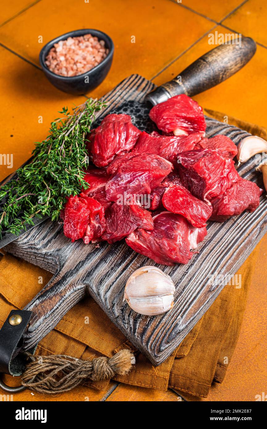 diced raw beef meat on wooden cutting board Stock Photo - Alamy