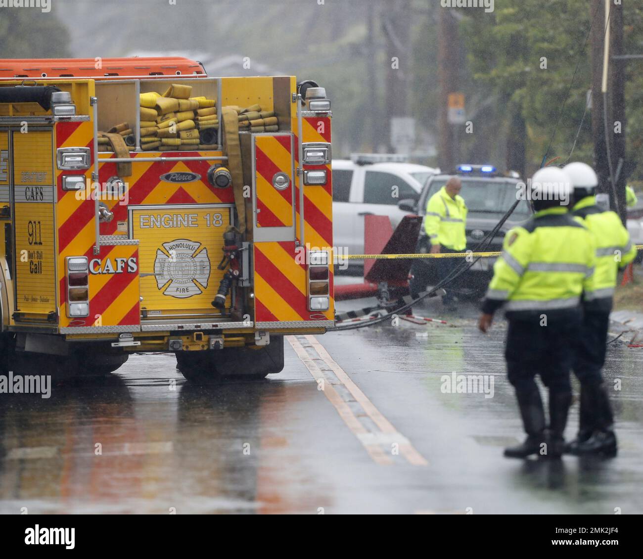 The tail of a crashed helicopter is seen in the middle of the street