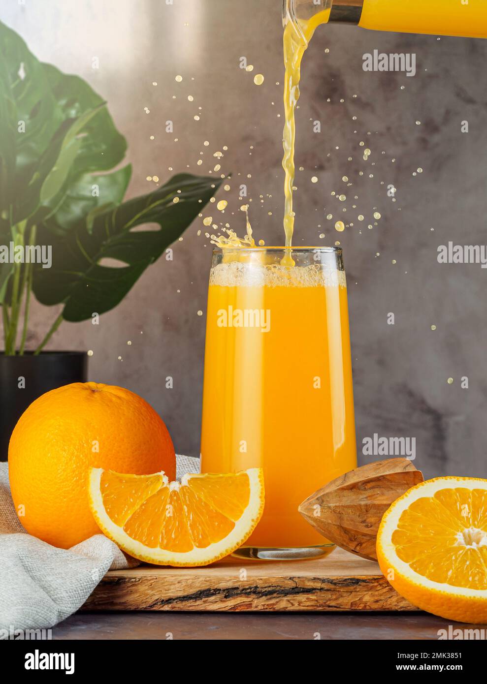 Still life with fresh orange juice in a glass with splashes and drops