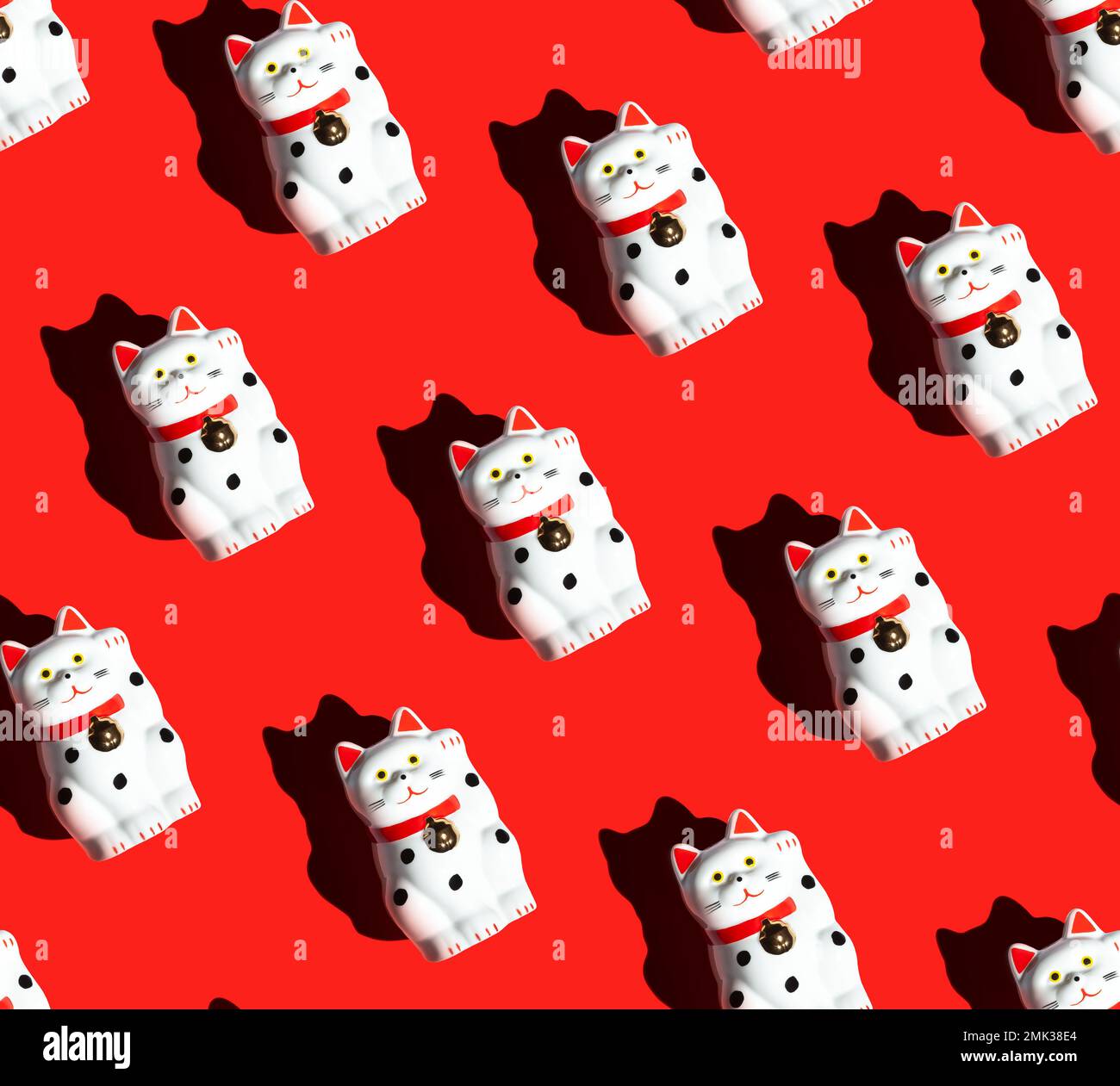 seamless pattern of manekineko cats on a red background. Beckoning cat