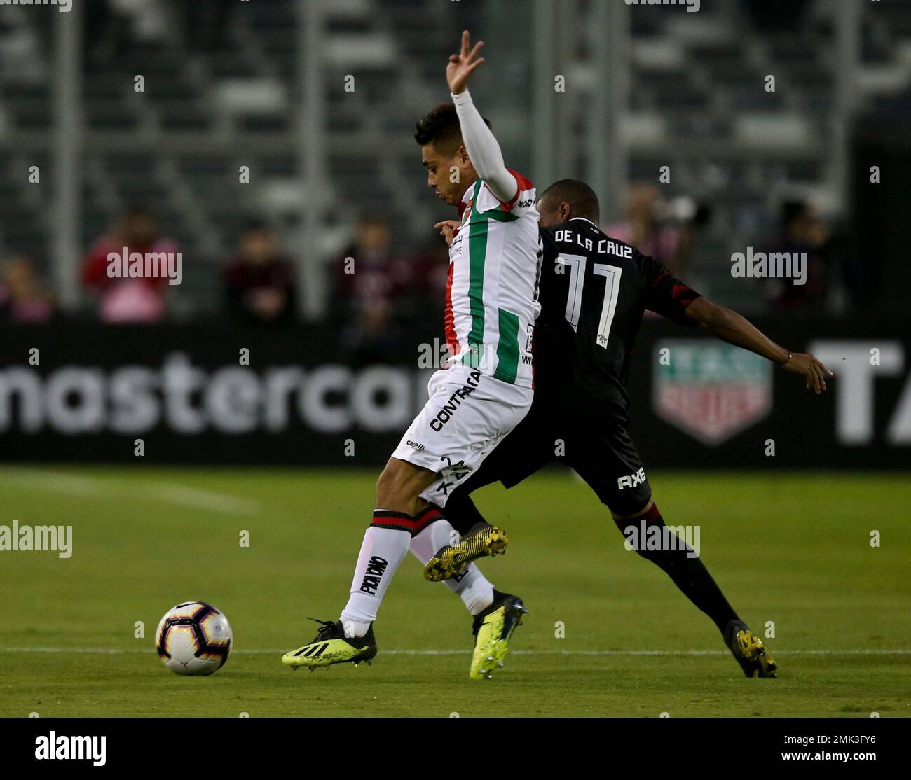 Diego De La Cruz Arcosa of Argentina's River Plate, right, fights the ball  with Fabian Ahumada of Chile's Palestino during a Copa Libertadores soccer  match in Santiago, Chile, Wednesday, April 24, 2019. (