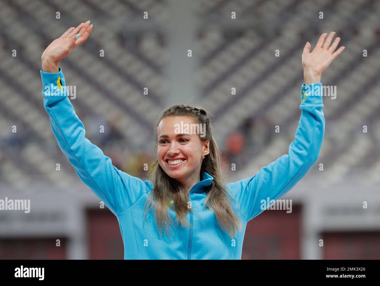 Kazakhstan's Olga Safronova celebrates on the podium after winning gold