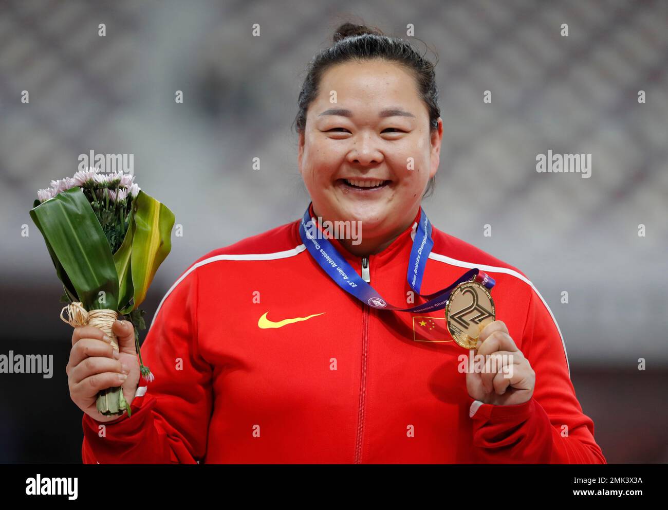 China's Wang Zheng celebrates with her gold medal for the women's