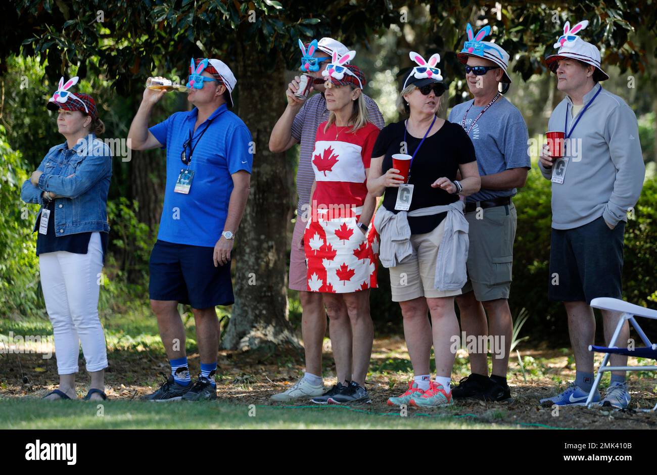 Patrons watch Dustin Johnson on the seventh hole dressed with Easter Bunny ears during the final round of the RBC Heritage golf tournament at Harbour Town Golf Links on Hilton Head Island,