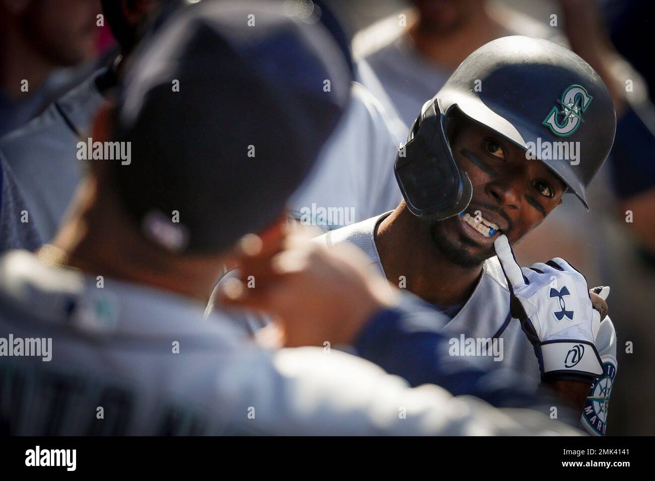 Seattle Mariners' Dee Gordon celebrates in the dugout after a home