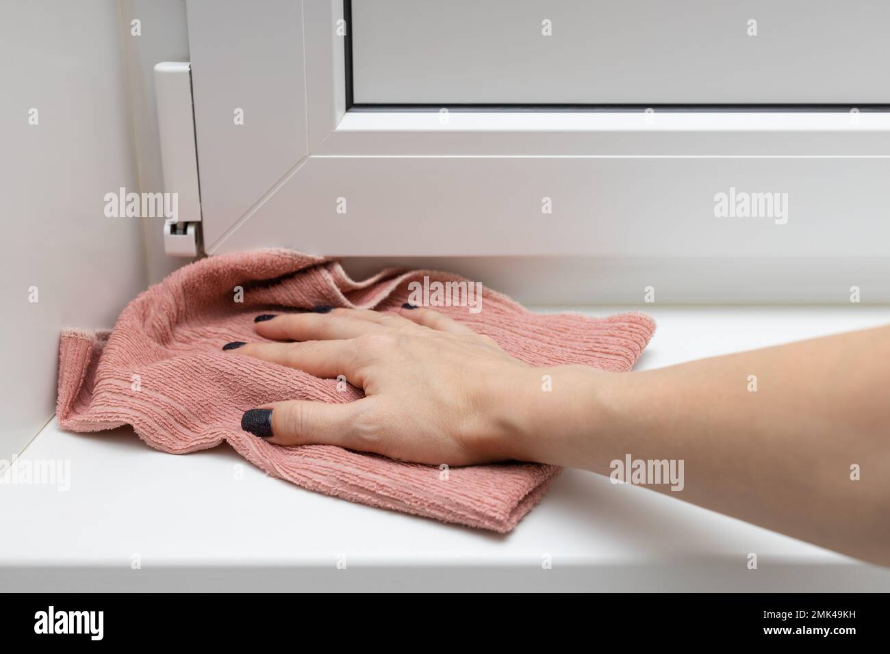 woman wipes the threshold at the door with a rag. woman mopping the floor. house dust cleaning