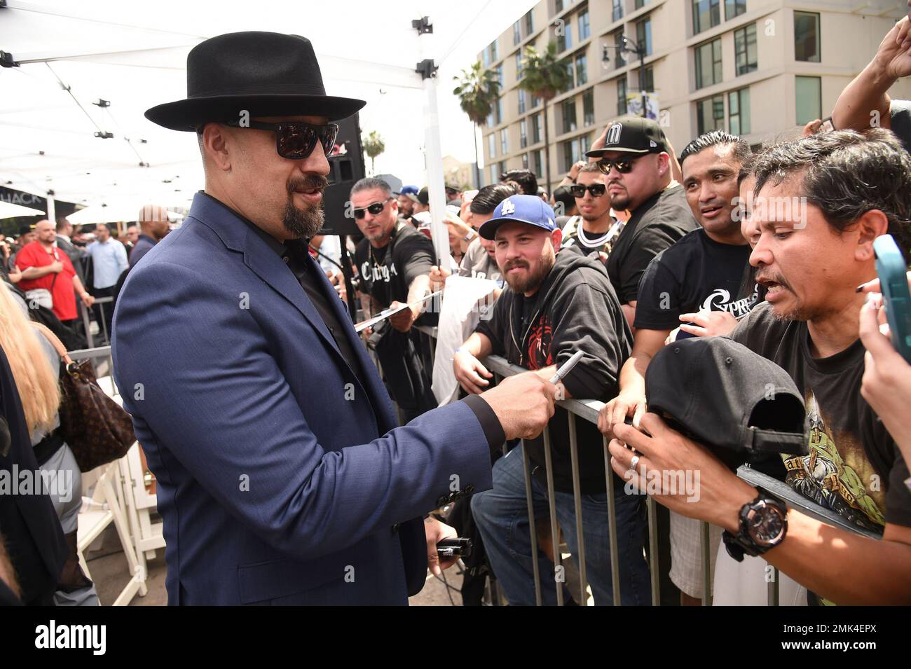 B-Real, of hip-hop group Cypress Hill, right, signs autographs ...