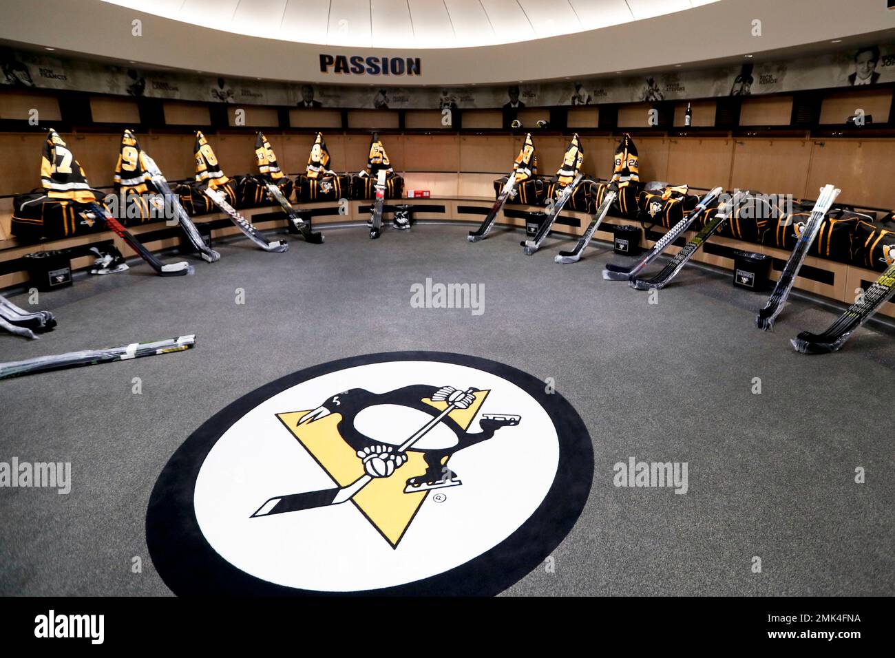 The team logo is in the center of the Pittsburgh Penguins locker room  before players come in to talk to the media before leaving for the off  season two days after being, image size:1300x956