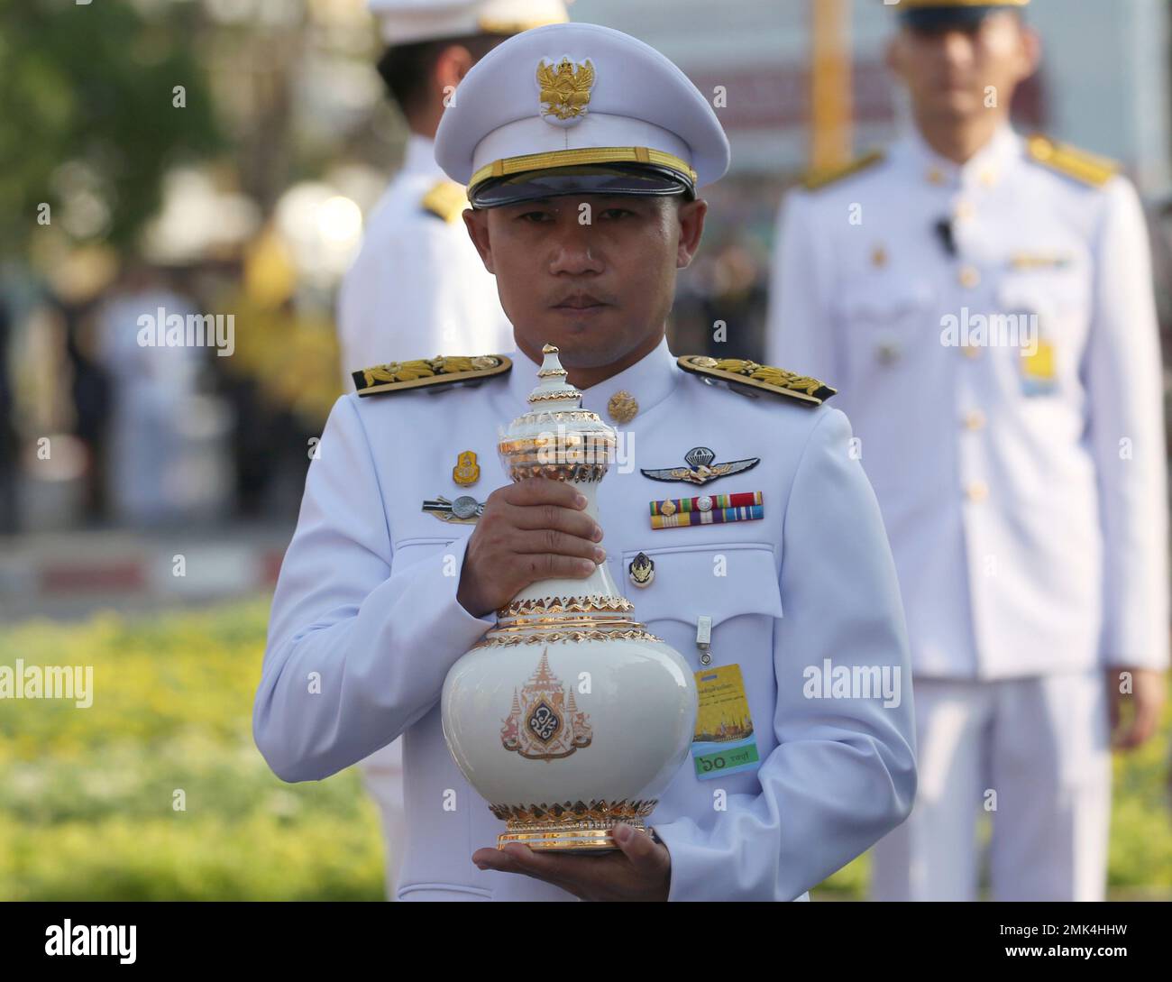 A Thai Royal Palace official carries a container with sacred water ...