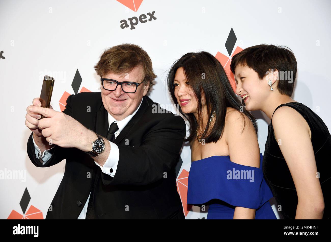 Filmmaker Michael Moore, left, takes a selfie with Sonia Low and daughter  Juliette Low at the Apex for Youth 27th annual Inspiration Awards gala at  Cipriani Wall Street on Wednesday, April 17,, image size:1300x953