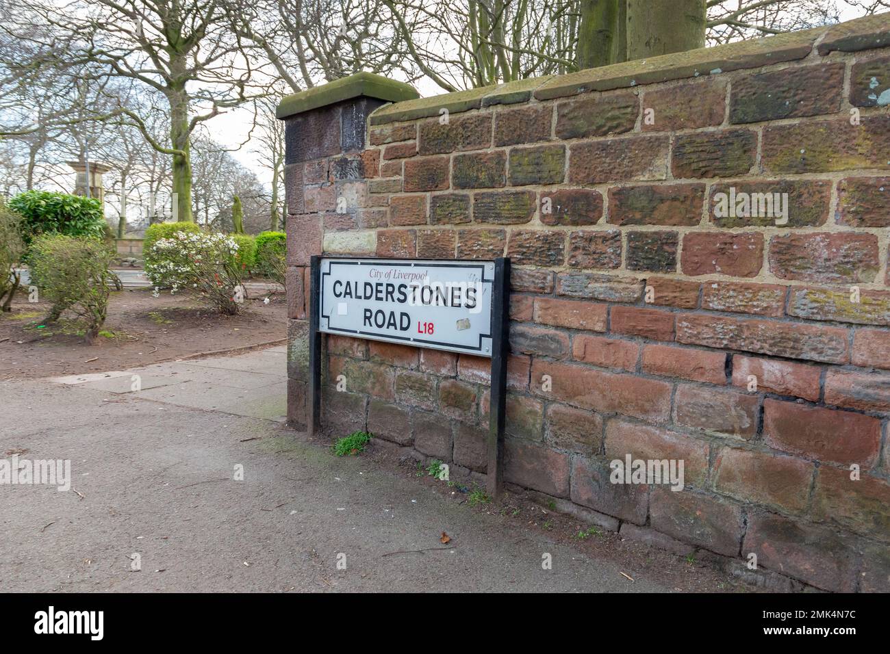 Liverpool, UK Calderstones Road signpost against a brick wall on the perimeter of Calderstones
