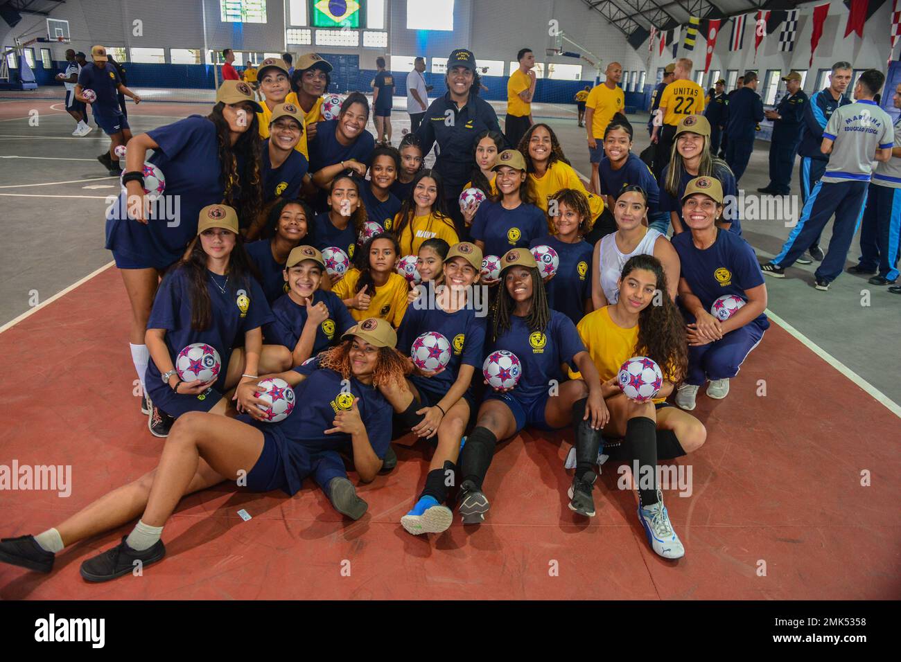 RIO DE JANEIRO (Sept. 5, 2022) Women from multinational forces pose for a  photo with local girls who participated in a community relations event  conducted prior to the beginning of UNITAS LXIII,