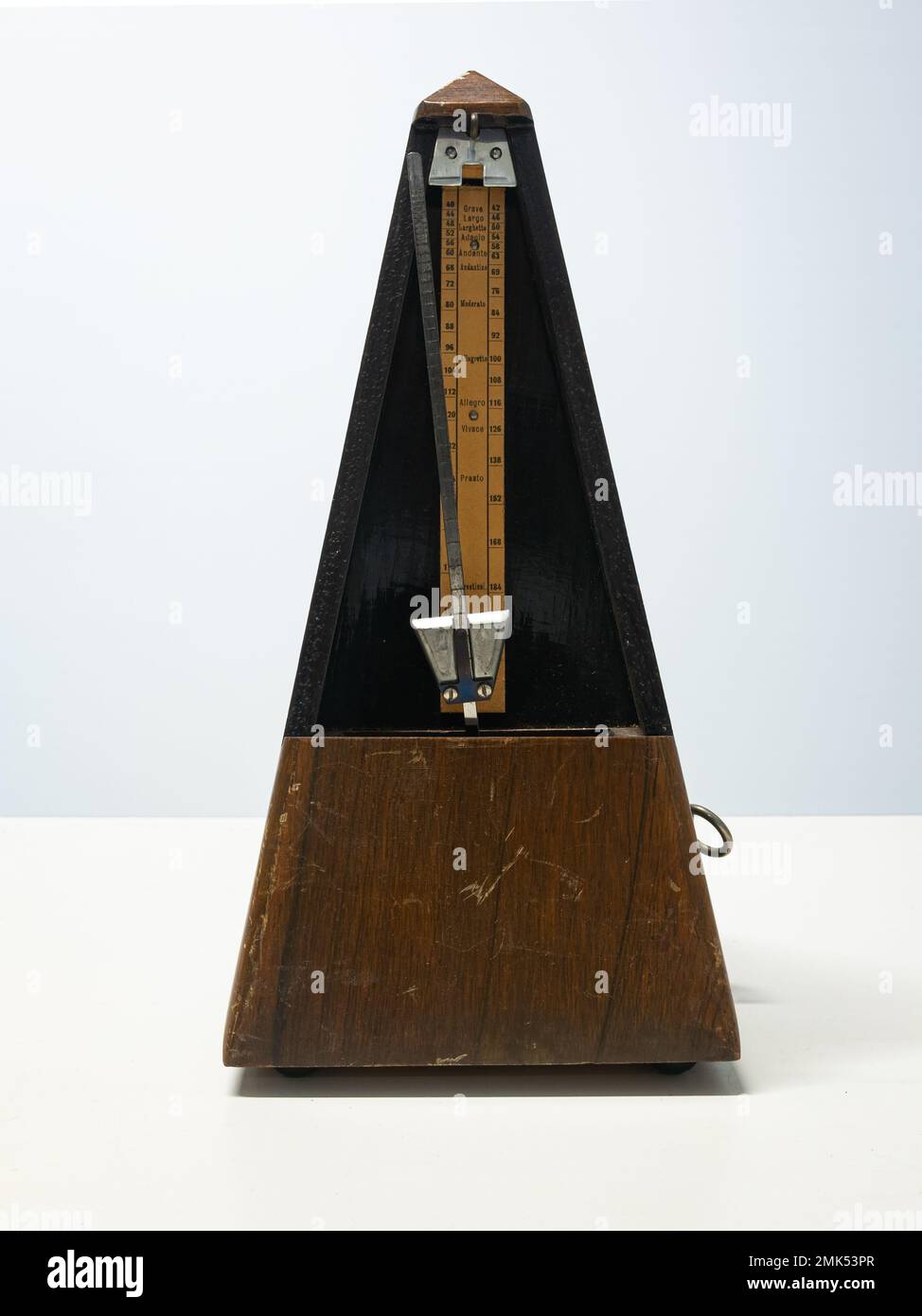 A metronome is a device that produces an audible click or other sound at a  regular interval that can be set by the user, typically in beats per minute  Stock Photo 