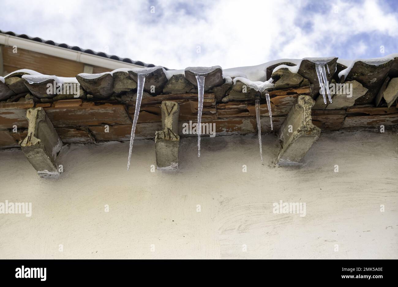 Roof with ice and snow at home, ceramic construction, temporary Stock Photo
