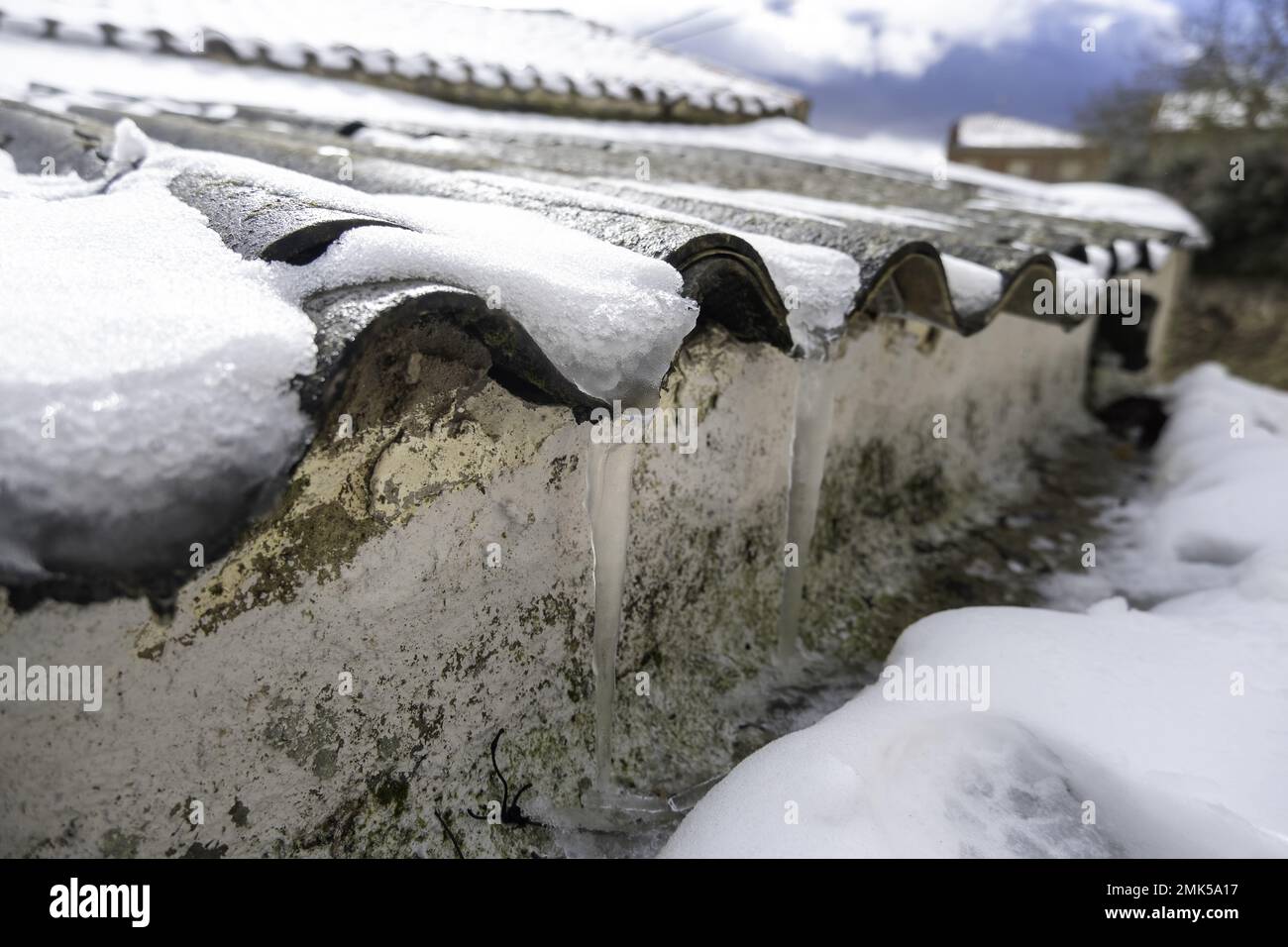 Roof with ice and snow at home, ceramic construction, temporary Stock Photo