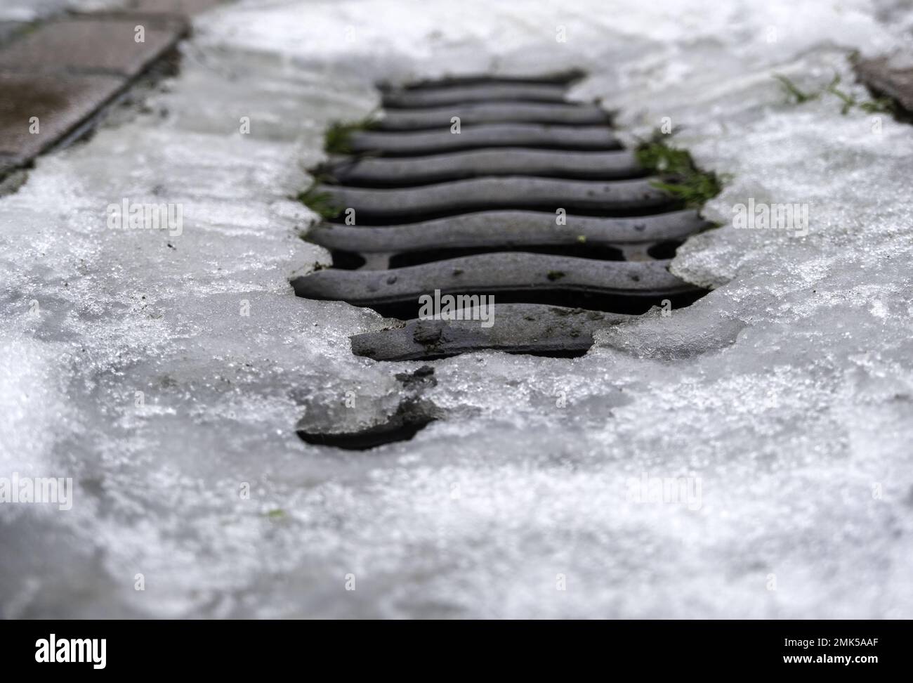 Manhole with ice and snow in urban street, temporary and winter Stock Photo