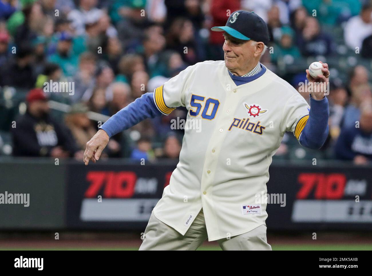 Former Washington Gov. Dan Evans throws out the first pitch of a baseball  game between the Seattle Mariners and the Houston Astros, Friday, April 12,  2019, in Seattle. Evans is wearing a