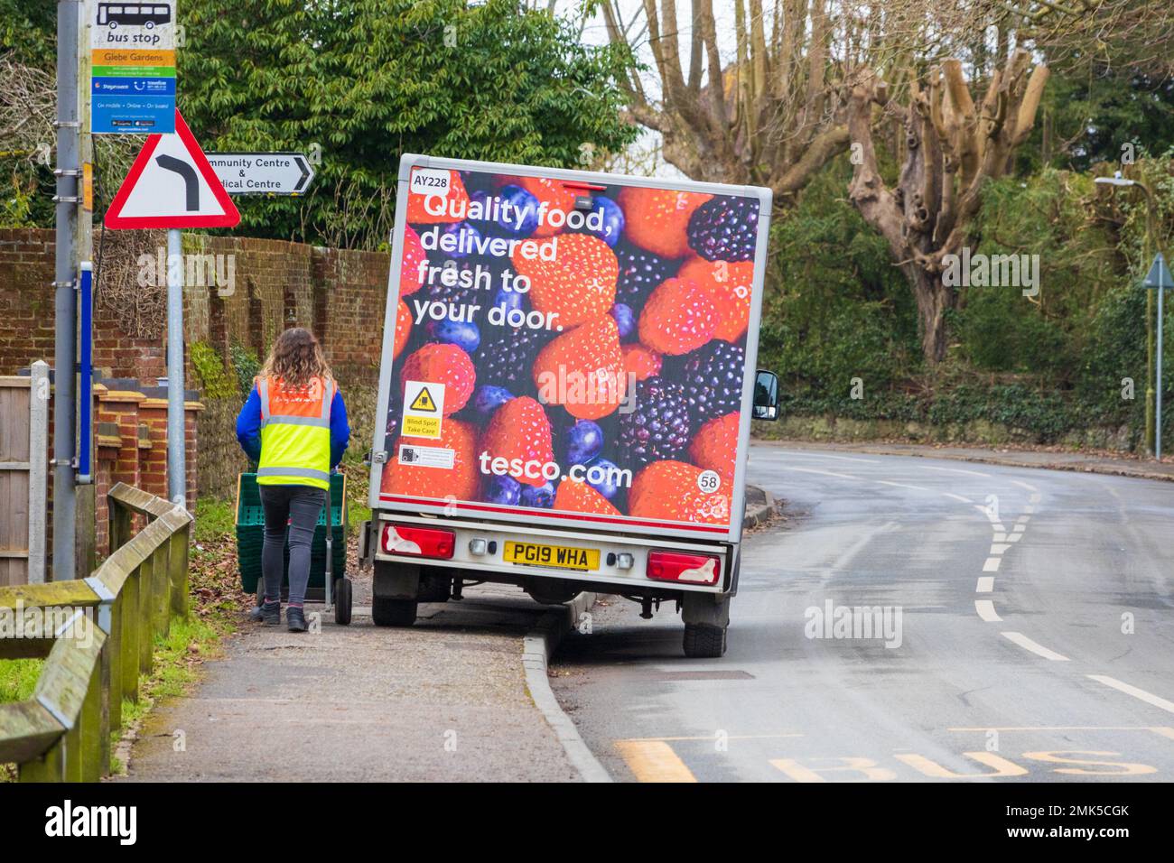 Tesco van delivery driver parked on pavement in country village, lenham, kent, uk Stock Photo