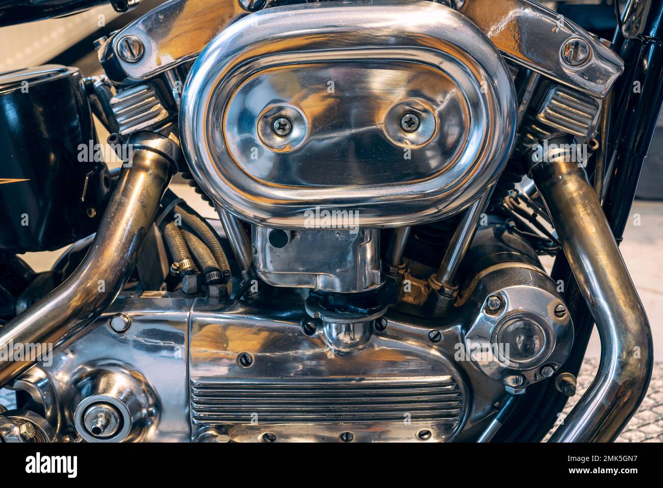Fragment of v-twin engine in old-fashioned chopper. Chrome motor housing. Stock Photo
