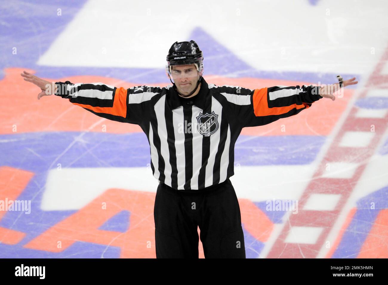 NHL referee Francois St. Laurent gestures during overtime of Game 1 of an NHL hockey first-round playoff series between the New York Islanders and the Pittsburgh Penguins, Wednesday, April 10, 2019, in
