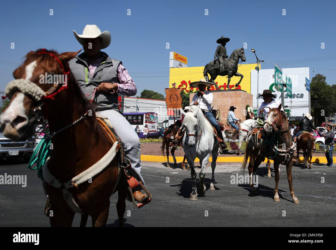 Charros, as Mexican cowboys are known, sit on their horses after paying tribute to Mexican