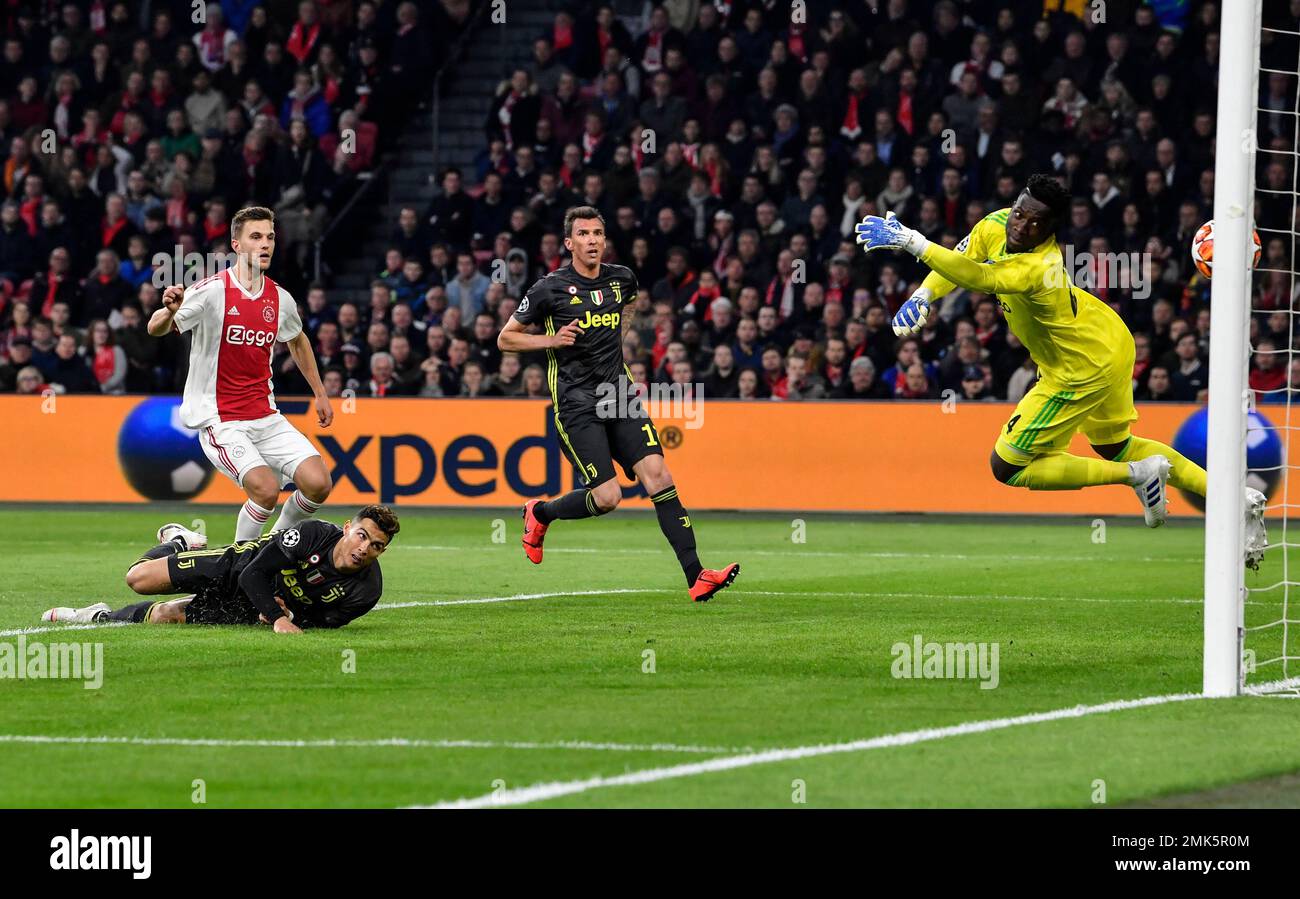 Ajax goalkeeper Andre Onana, right, fails to save the ball as Juventus' Cristiano  Ronaldo, bottom left, scores his side's opening goal during the Champions  League quarterfinal, first leg, soccer match between Ajax