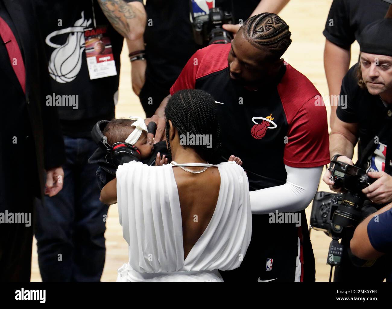 Miami Heat guard Dwyane Wade greets his daughter Kaavia James, and wife