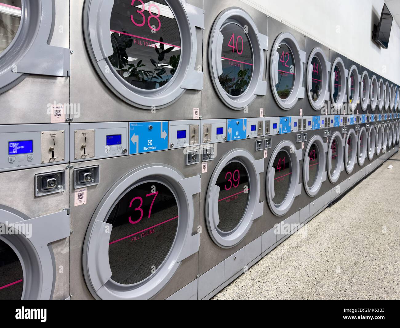 Coin laundry shop with washing machines Stock Photo
