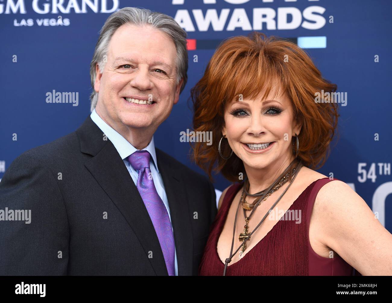 Anthony Lasuzzo, left, and Reba McEntire arrive at the 54th annual