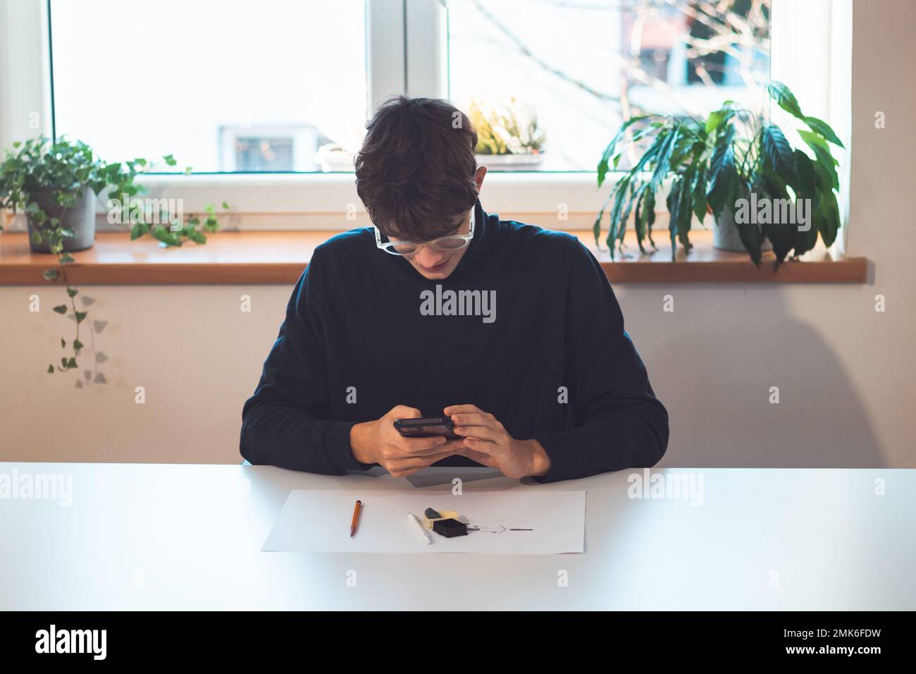 Brown-haired young architect creates new product designs for a new ...
